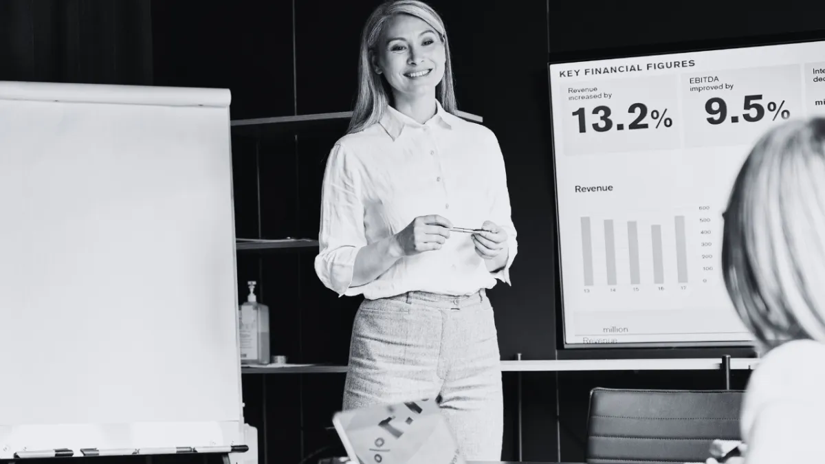 A woman presenting a report to a team about business growth