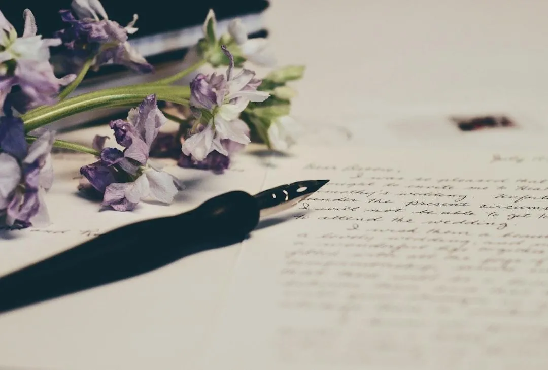 Pen with paper and flower
