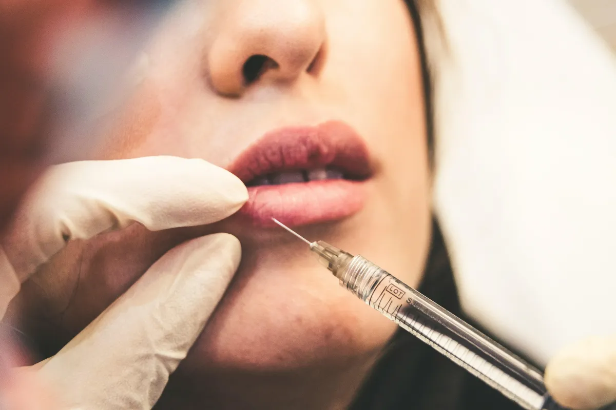 Woman getting a face injection