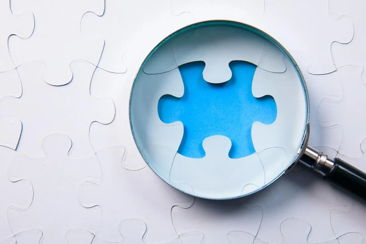 Magnifying glass over missing puzzle
