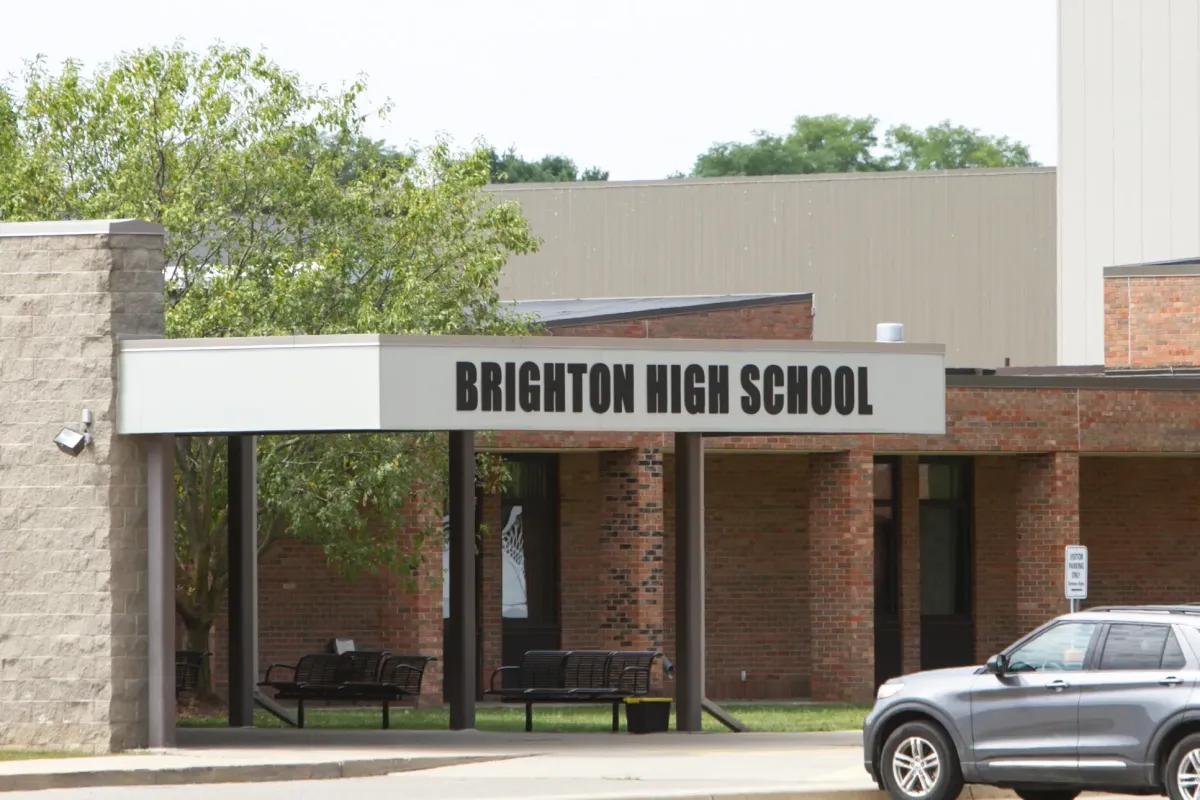 Modern school building and happy children outside in Brighton, Michigan