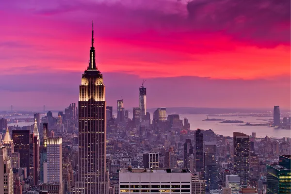 An image capturing a bird's-eye view of a sunset over Queens, NY, highlighting the Woodside neighborhood, where Aloha Laundry Life has announced its new partnership with Woodside Laundry.