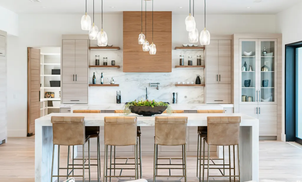 cerletti & kennedy remodeling - elegant kitchen with large dining table and hanging lights above