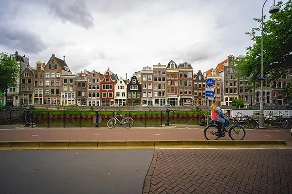 cyclist passing traditional houses in the netherlands