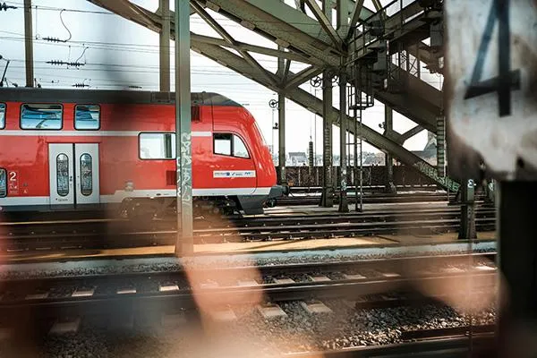 Red regional train goes from left to right