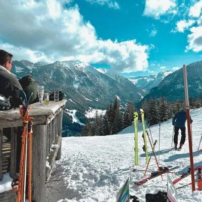 View from Alpine ski hut balcony with skis and snowy mountain scenery in the European Alps