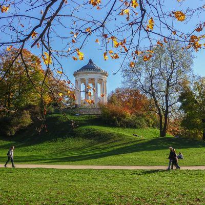 English Garden in Munich in September with lush greenery, wide walking paths, and people relaxing outdoors in the famous city park.