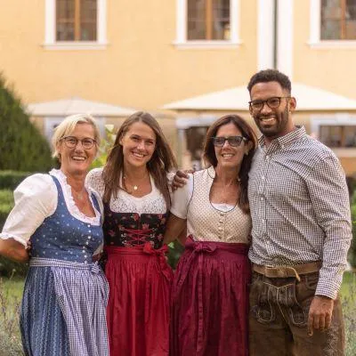 Family across generations wearing Dirndl and Lederhosen at Oktoberfest Munich, showcasing Bavarian culture, heritage, and traditional Tracht at the famous beer festival.