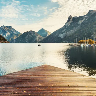 Scenic view of a lake with a boat and mountains in the background.