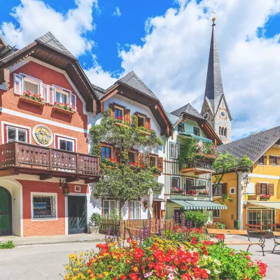 Traditional houses and a church in a town in the south of Germany with flowers in front.