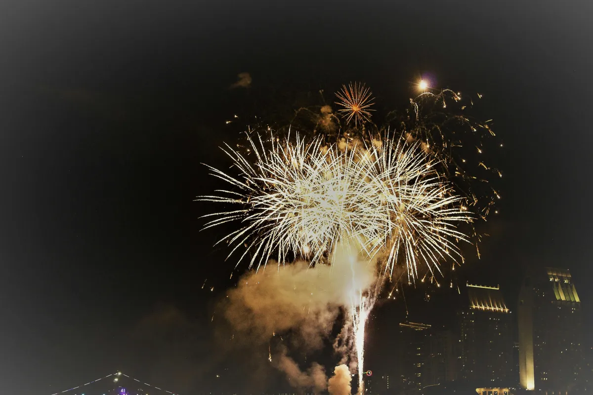 Colorful fireworks lighting up the night sky over Louisville with a festive atmosphere.