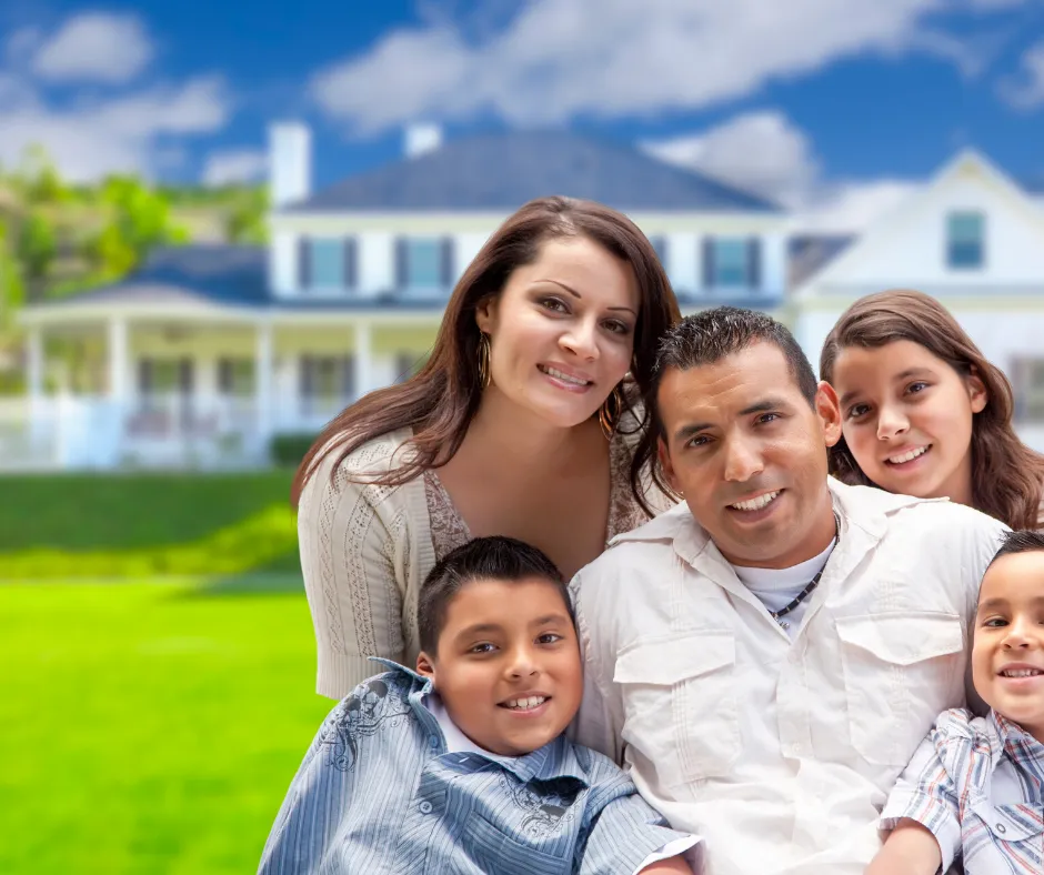 hispanic family in front of new home