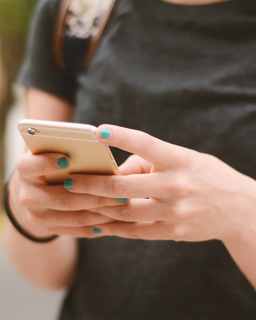 Someone holding a cellphone as if they're reading a text