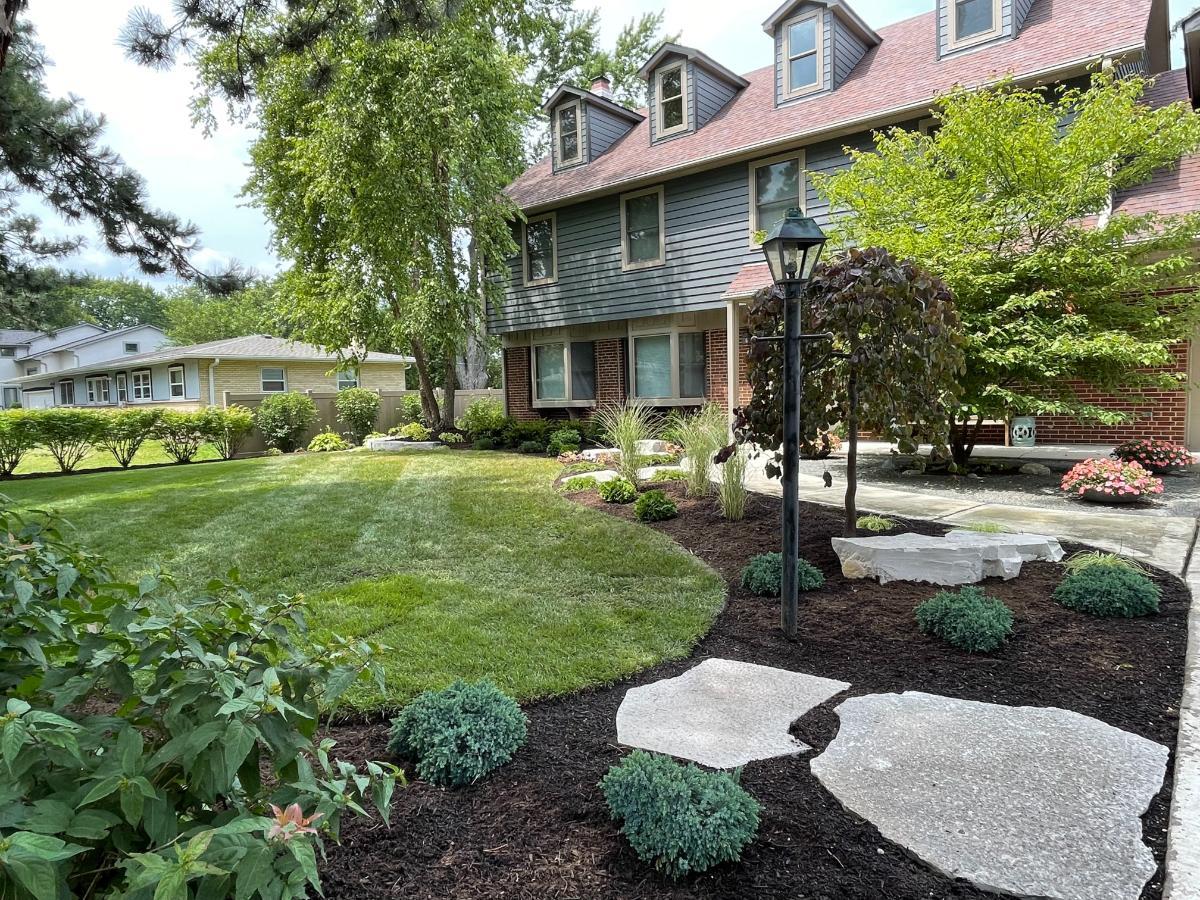 Charming Front Garden Landscaping with Artistic Planting and Curved Beds