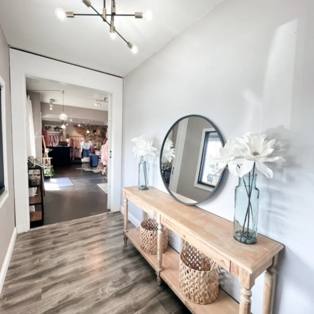 Exterior view of Sugarmama's Beauty Collab studio entrance with a glass door and signage.