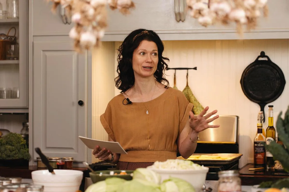 Laureen, Holistic Wellness Coach, presenting digestive wellness tips in a farm kitchen setting