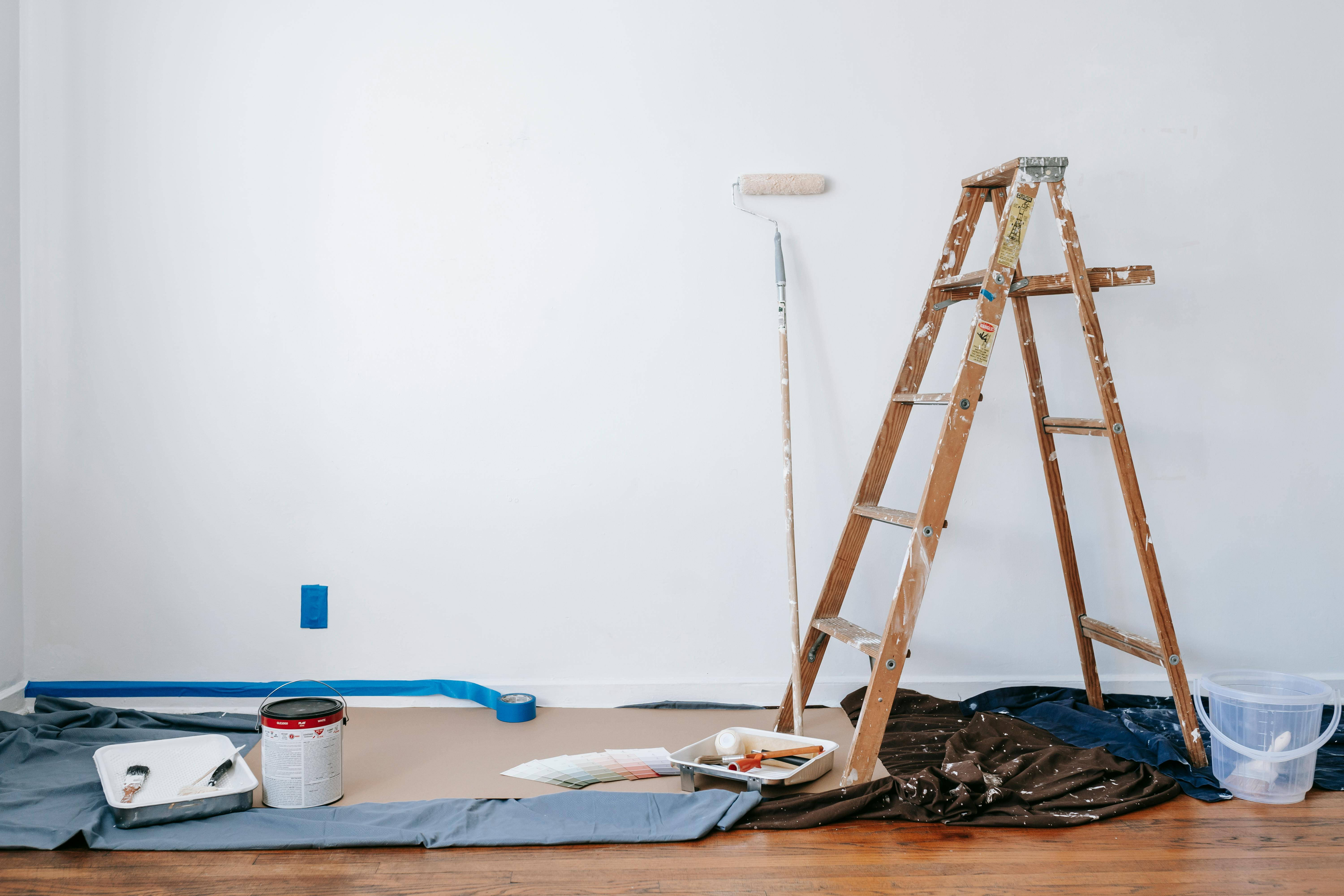 House renovation tools scattered around a room painted in white