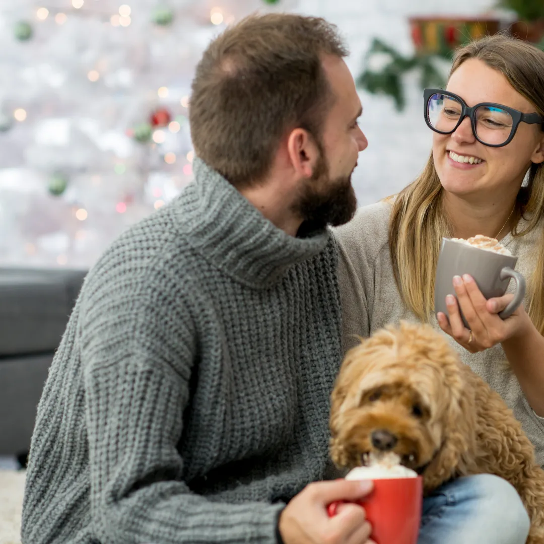 a couple holding a mug with hot chocolate