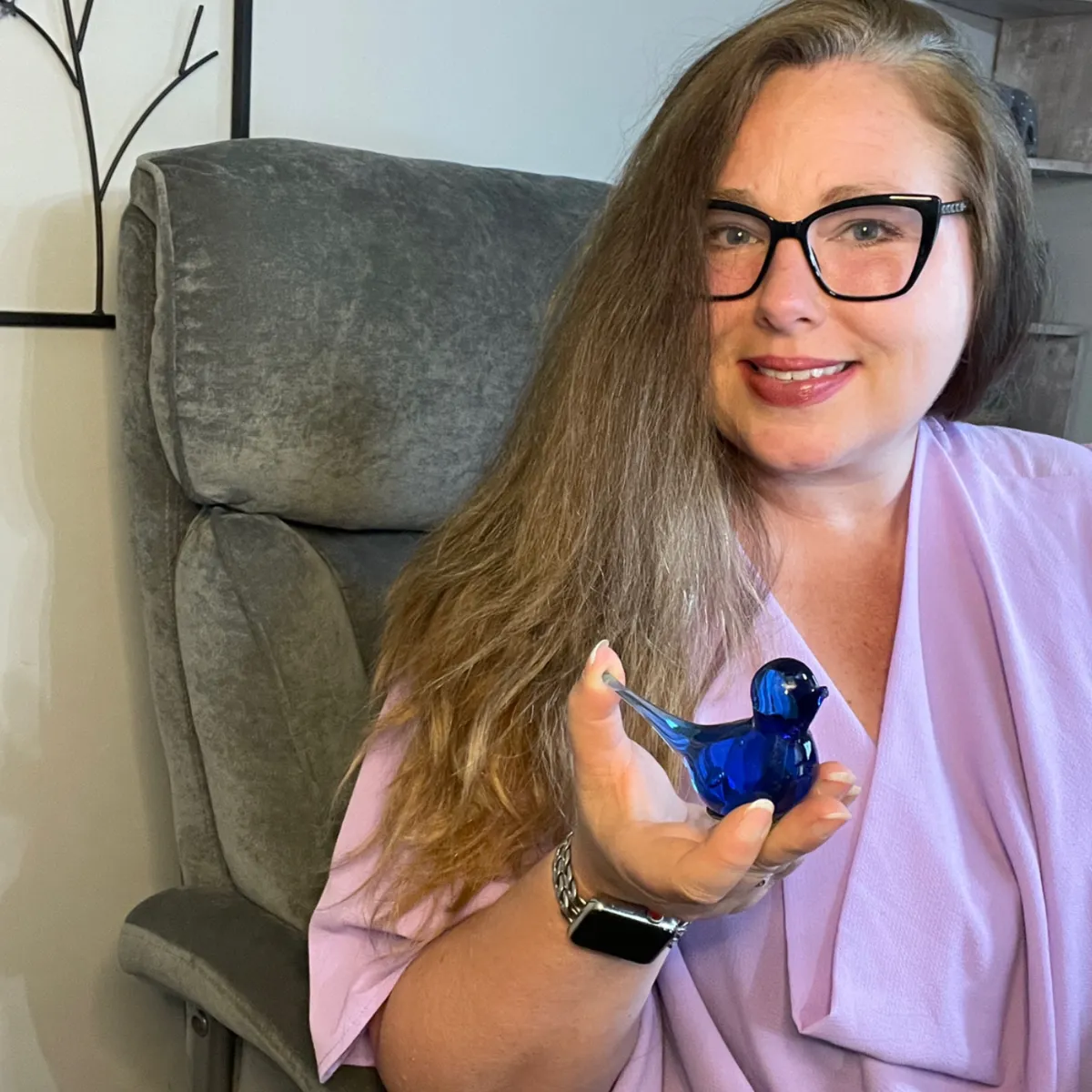 Image: of Christine Wade holding her grandmother's figurine