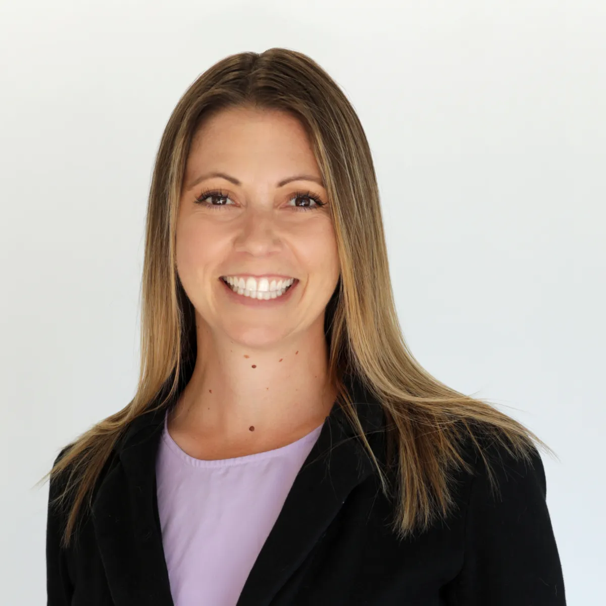 Shannon Godfrey smiling in a navy blazer, standing against a minimalist background with the article title in bold text.