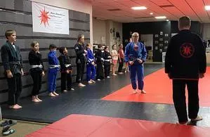 Clarksville TN Jiu-Jitsu instructor leading a dynamic class for kids, emphasizing self-defense, social skills, and physical fitness.