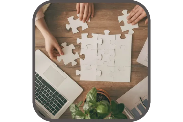 Business people working together on a jigsaw puzzle