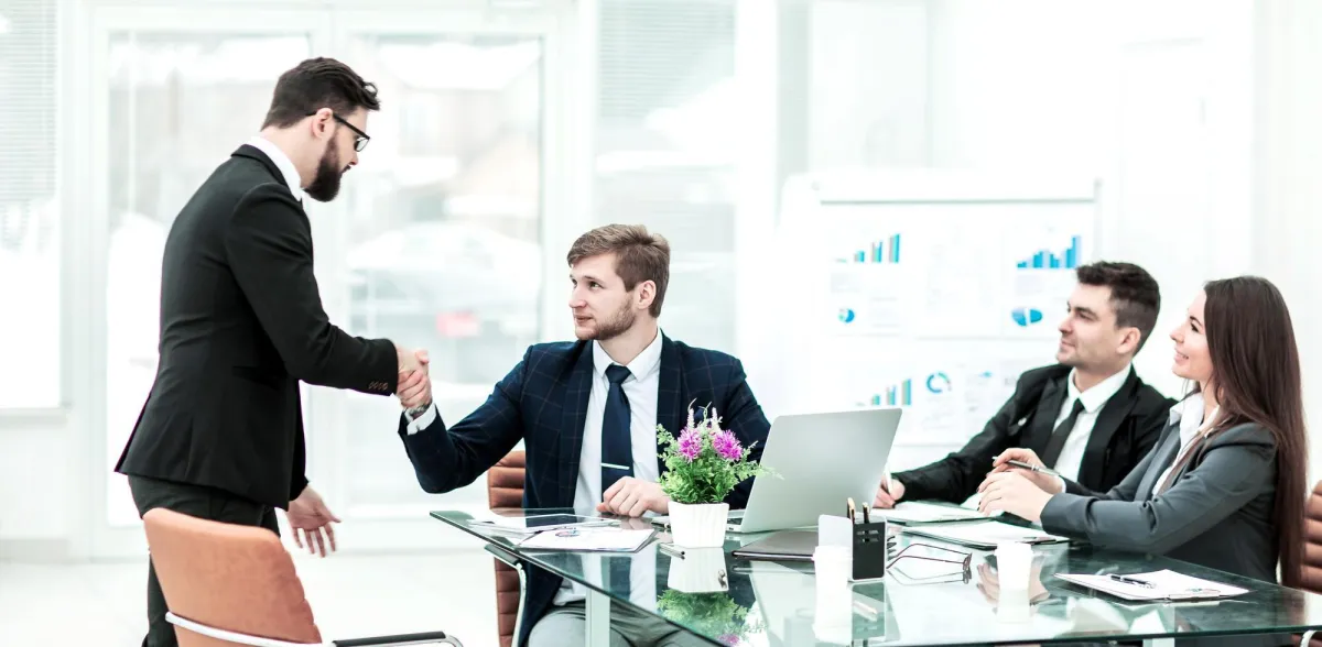 Muslim business owner in a meeting shaking hands MuslimFin