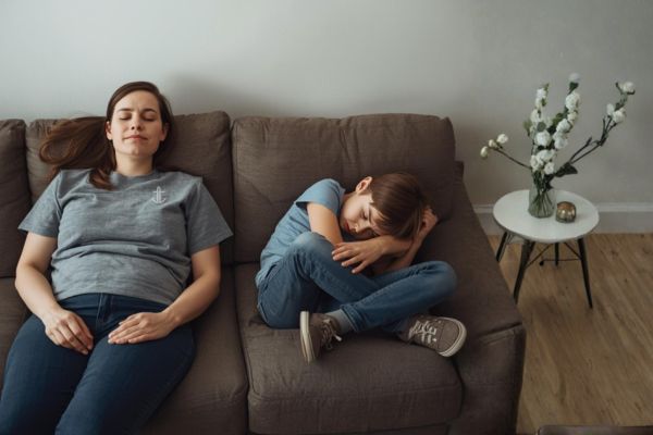 A calm caregiver sitting nearby while a child experiences big emotions, representing emotional intensity and regulation support in ADHD families.