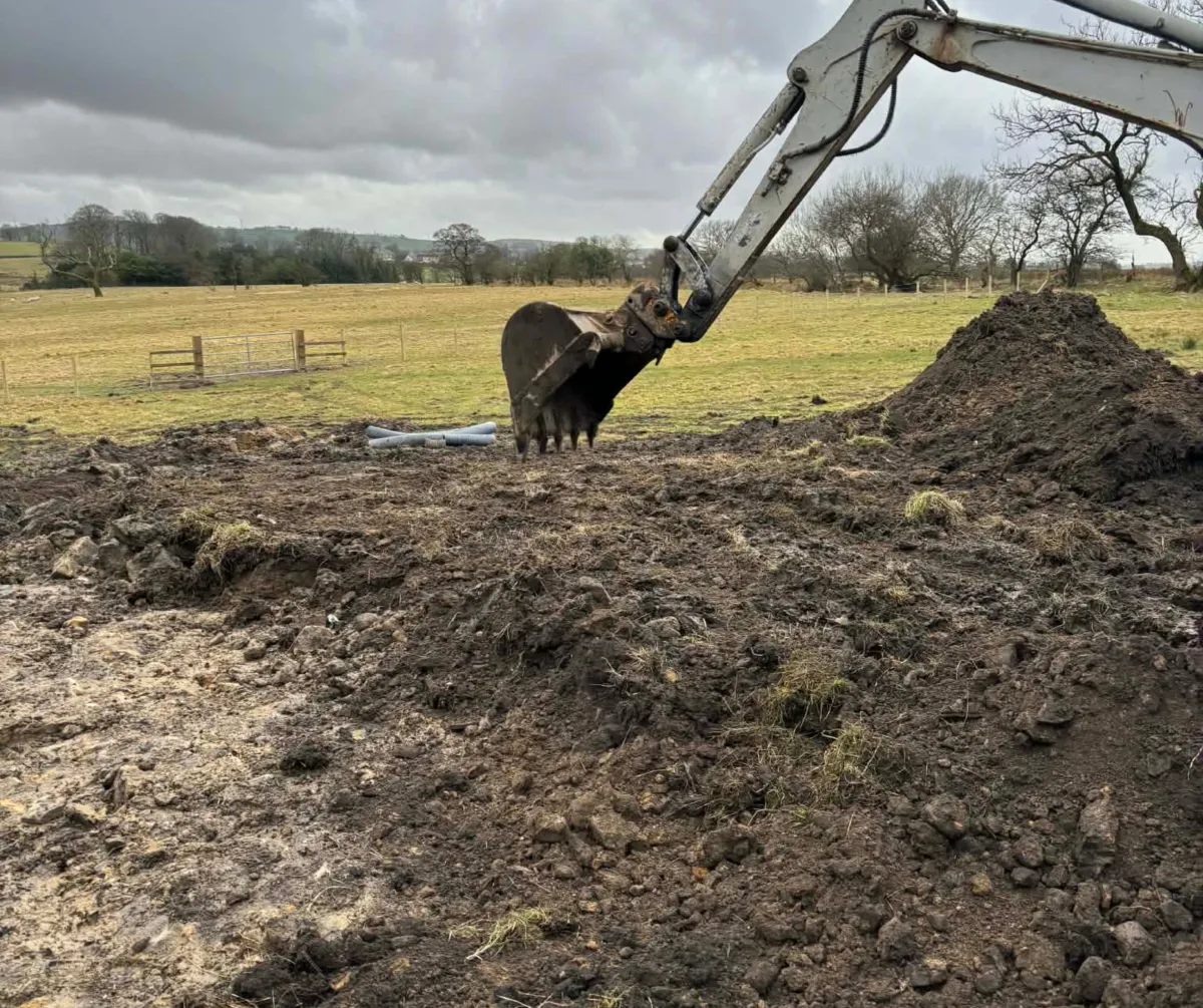 Excavator carrying out groundwork and site levelling in Lancashire