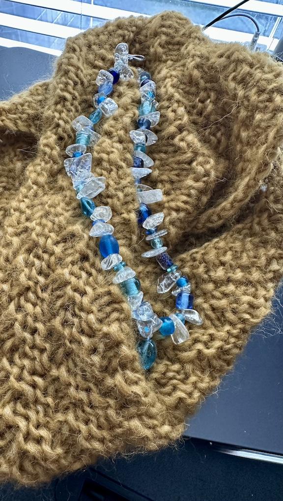 A cowl in the KnitPick's Wonderfluff yarn and a necklace made with glass beads and chips.