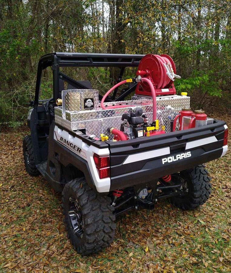Polaris Ranger equipped with Southern Rough wildland fire suppression skid featuring diamond plate storage, forestry hose reel, and drip torches