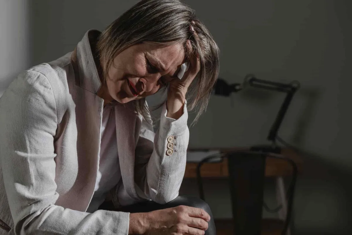 chiropractor getting stressed and crying while sitting alone at home