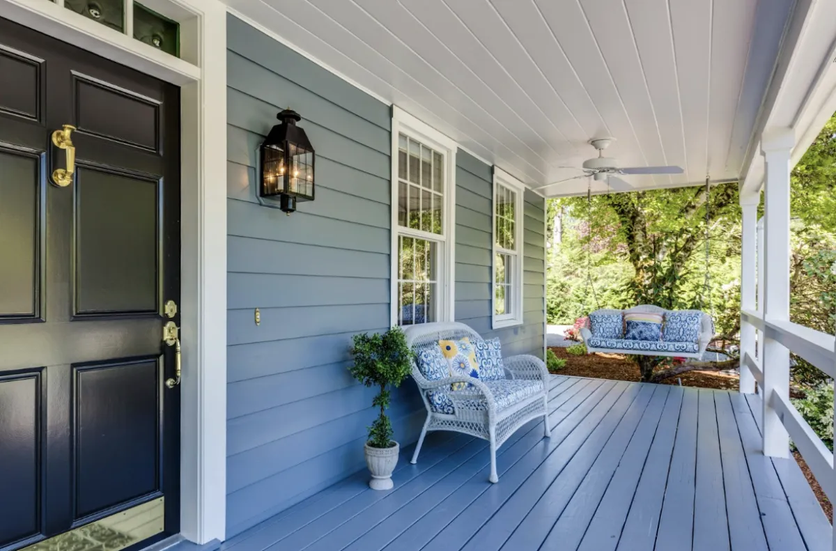 A single chair on a peaceful porch, surrounded by calm and natural light, symbolizing rest, stillness, and quiet reflection.