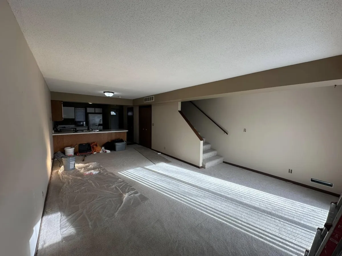 Interior basement in progress with new wall paint and protective floor covering