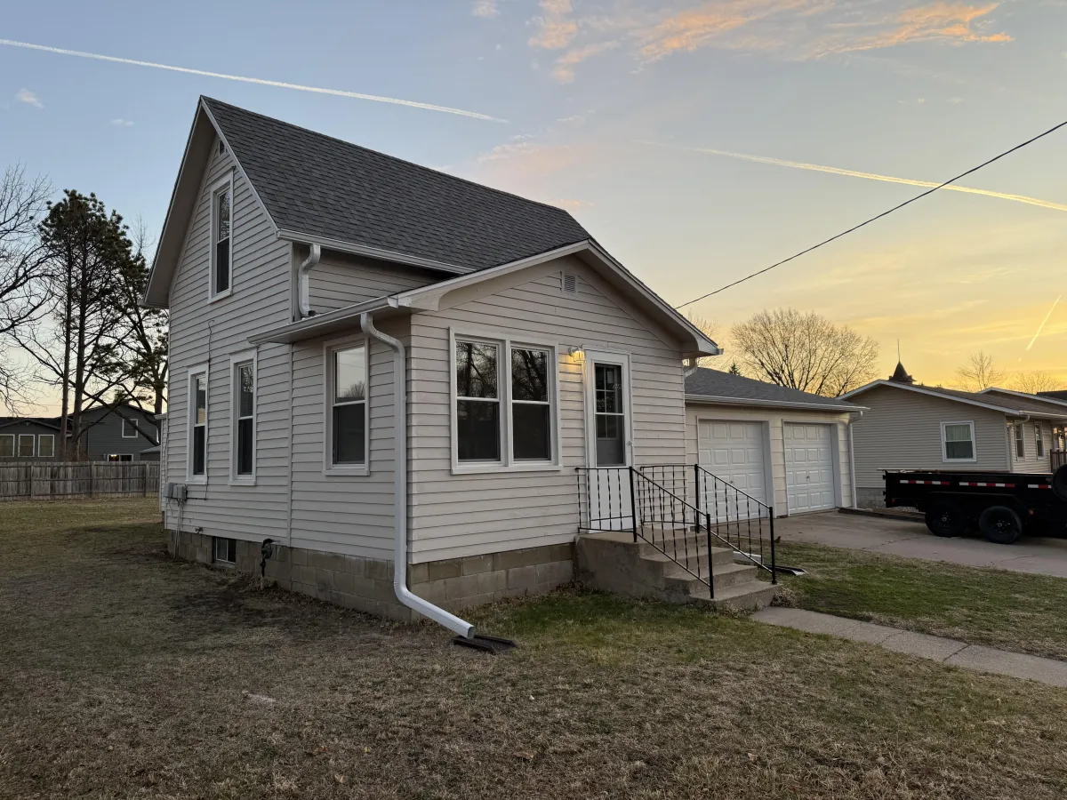 After exterior repaint: bold siding with bright white trim and clean finish