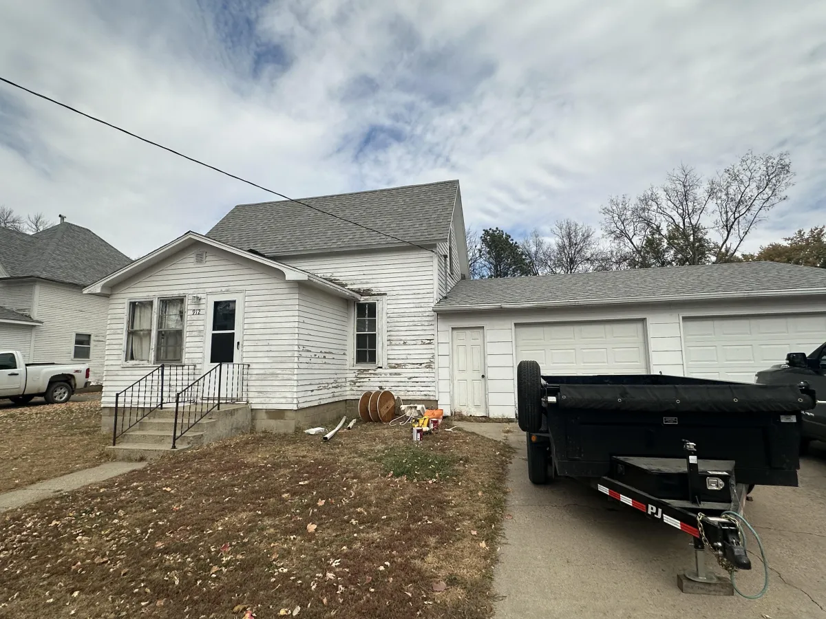 Before painting: aged siding with faded paint and dull color tones