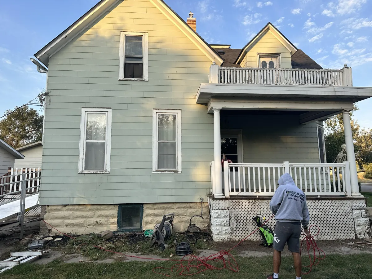 Before shot of home exterior with aged paint and weathered surfaces
