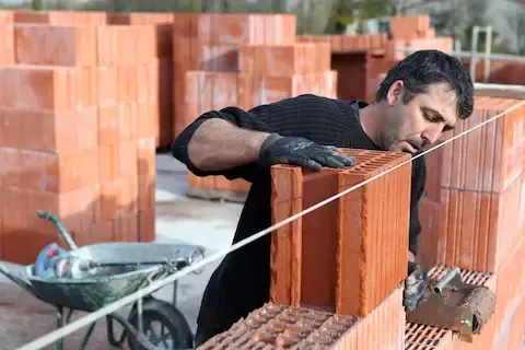Brick masonry installation forming new commercial exterior wall