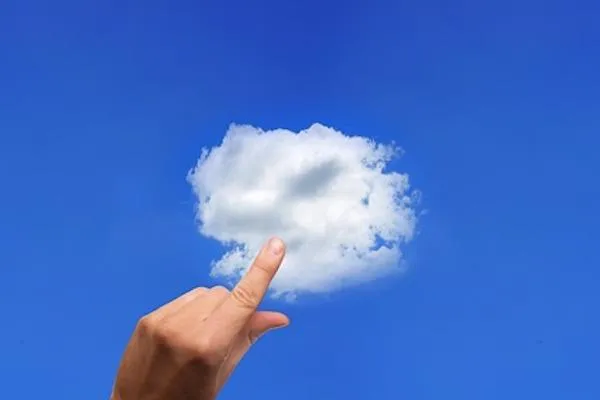 Hand touching cloud