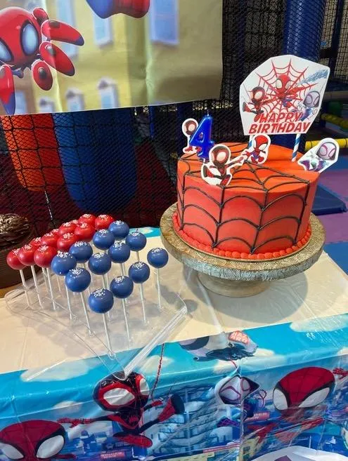 Spider-Man themed birthday cake and matching cake pops at Wild Child indoor playground in Bastrop, TX