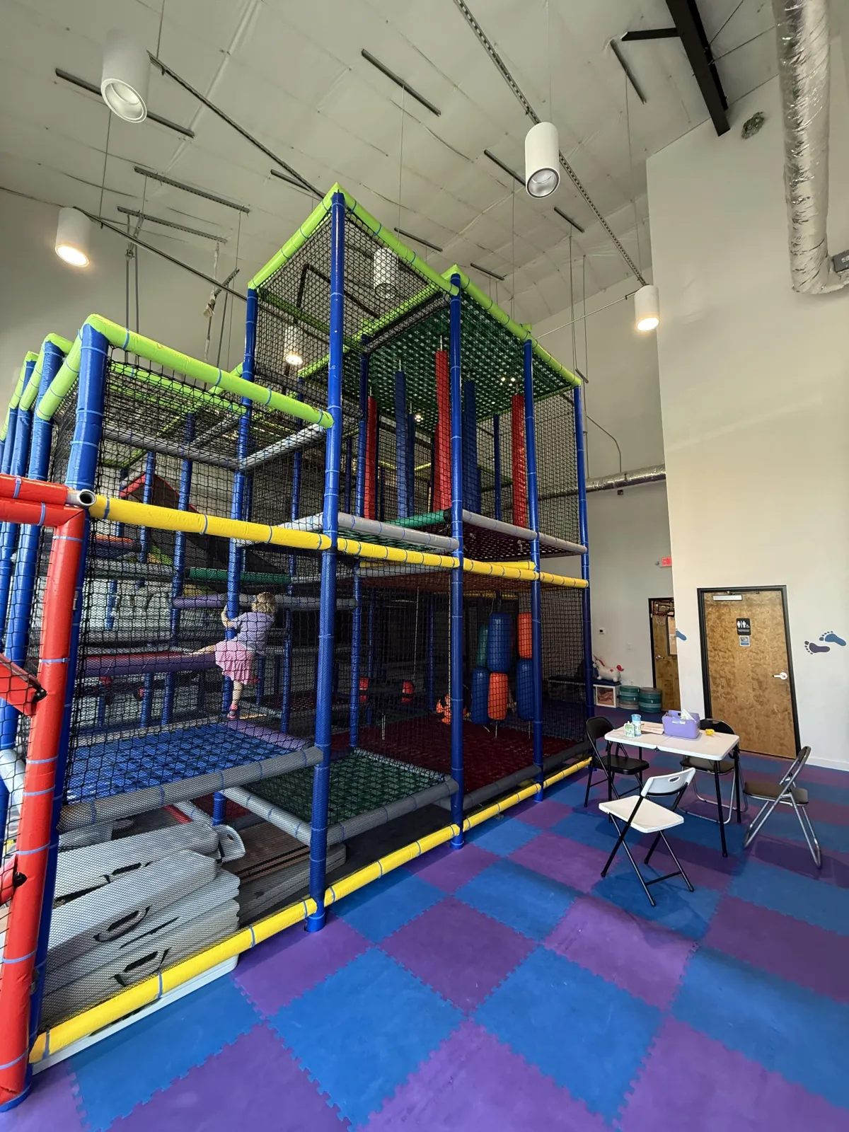 Wide shot of jungle-themed indoor play area at Wild Child indoor playground in Bastrop, TX