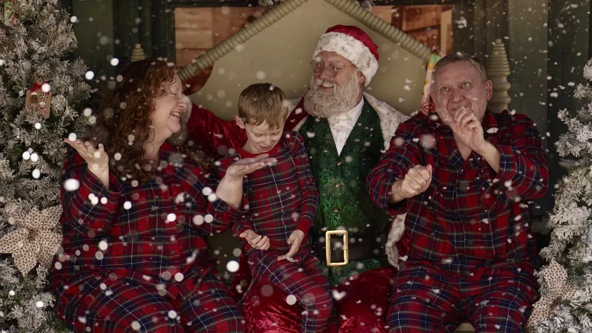 A family portrait with Santa Clause in the snow