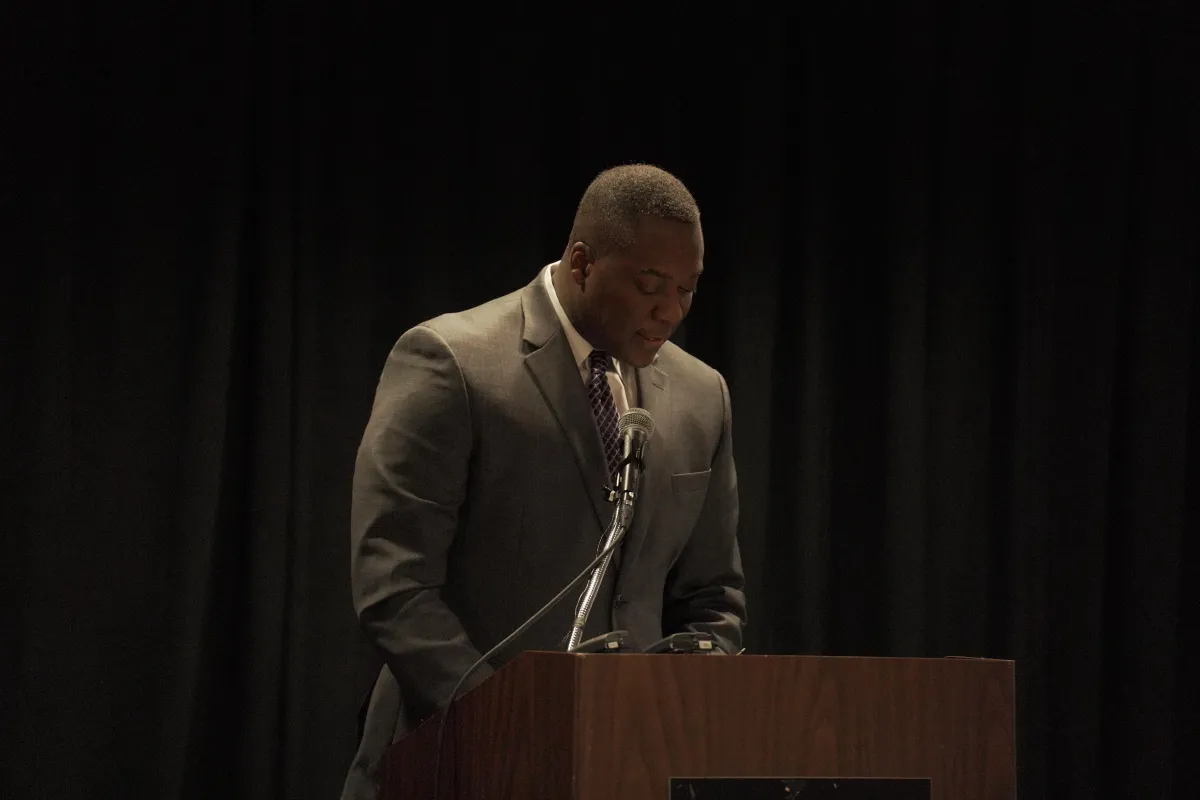 Calvin Ball speaking at a Howard County luncheon, exuding leadership and influence.
