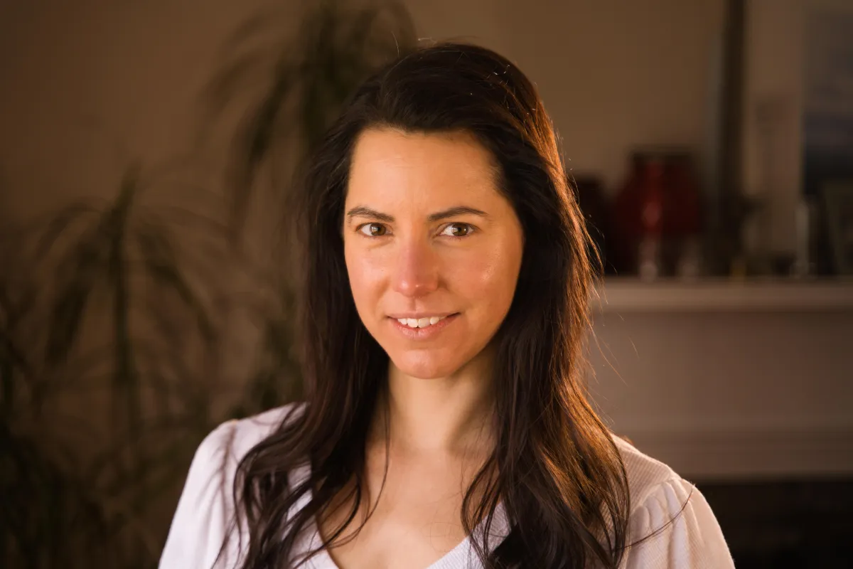 Professional headshot of a brunette American actress, capturing confidence.