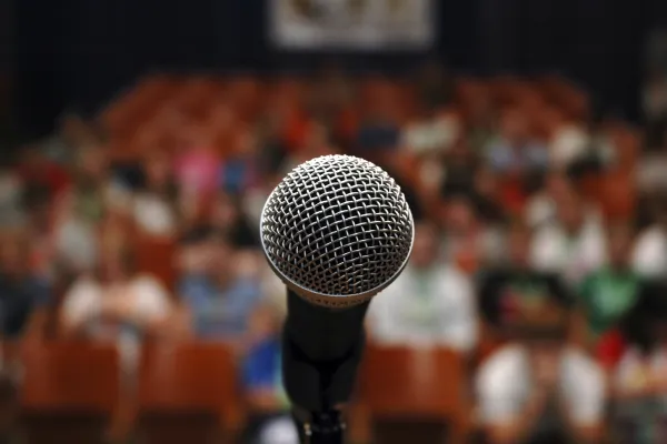 Microphone on a stage facing an audience