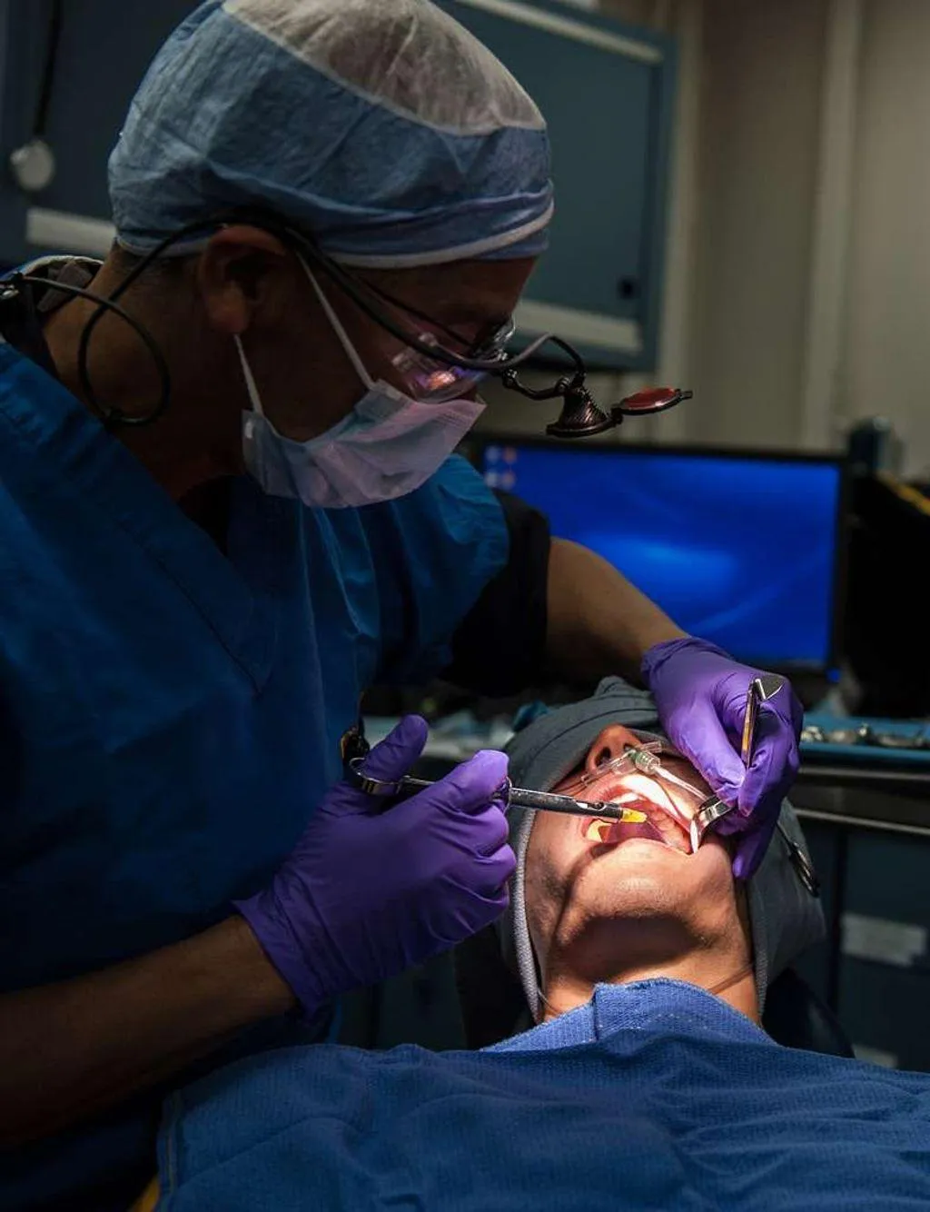 Dentist working on patient for wisdom tooth extraction