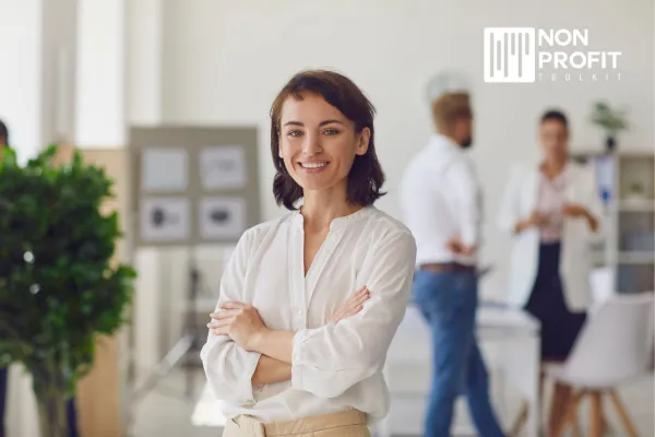 Happy Successful Business Lady or Company Employee Standing in Office Looking at Camera and Smiling