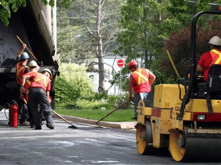 Workers repairing pothole