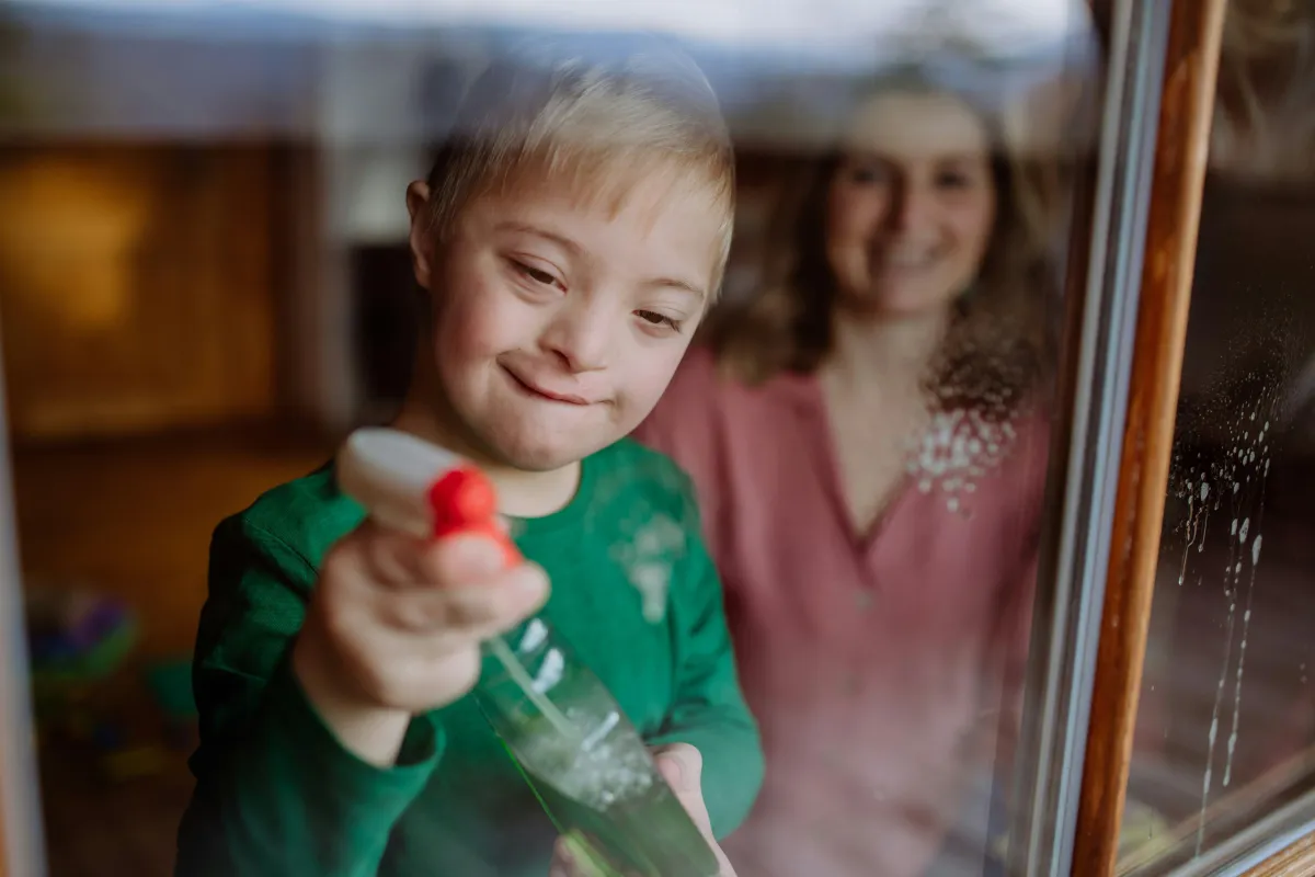 Little boy cleaning windows