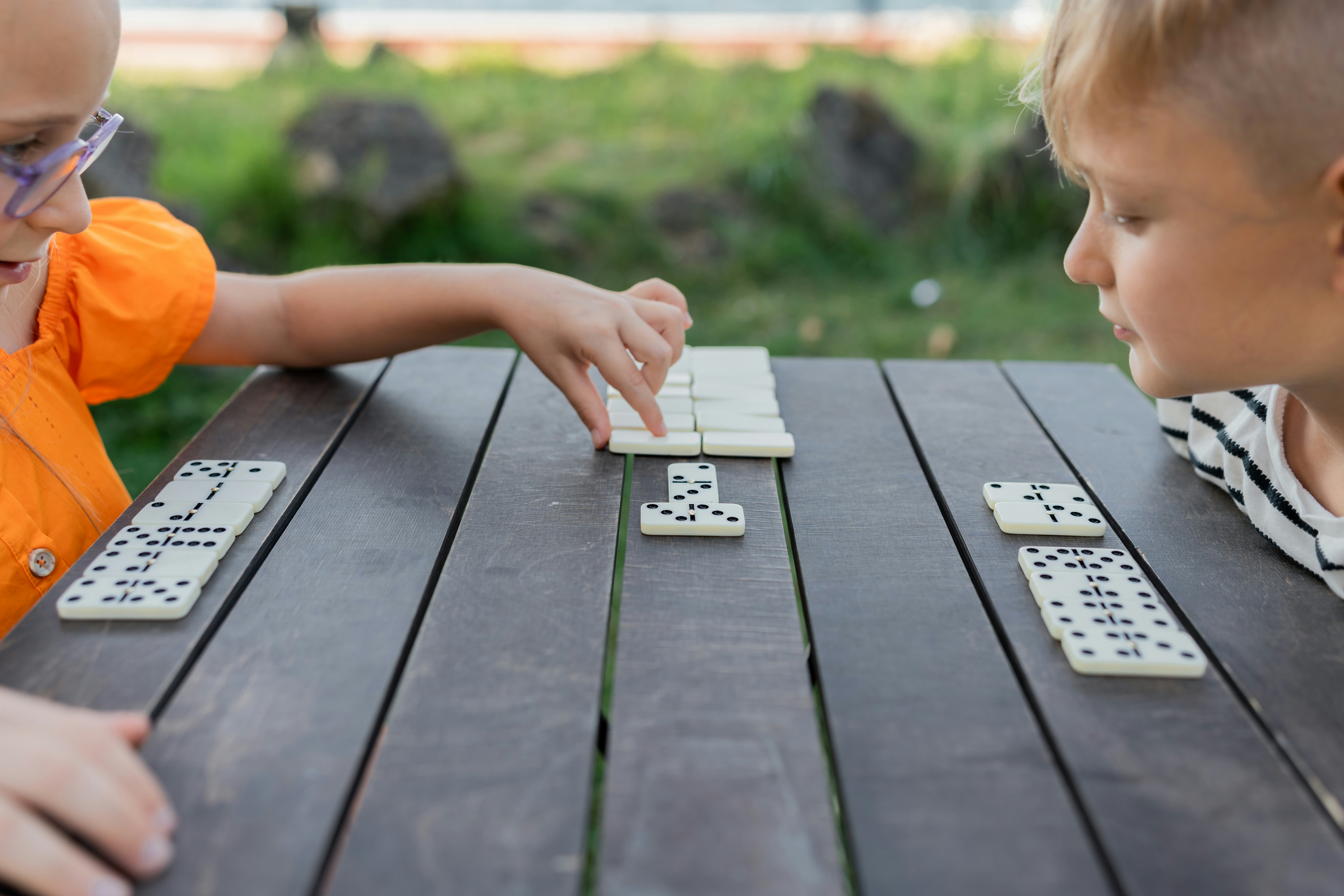 Girl and boy playing dominos 